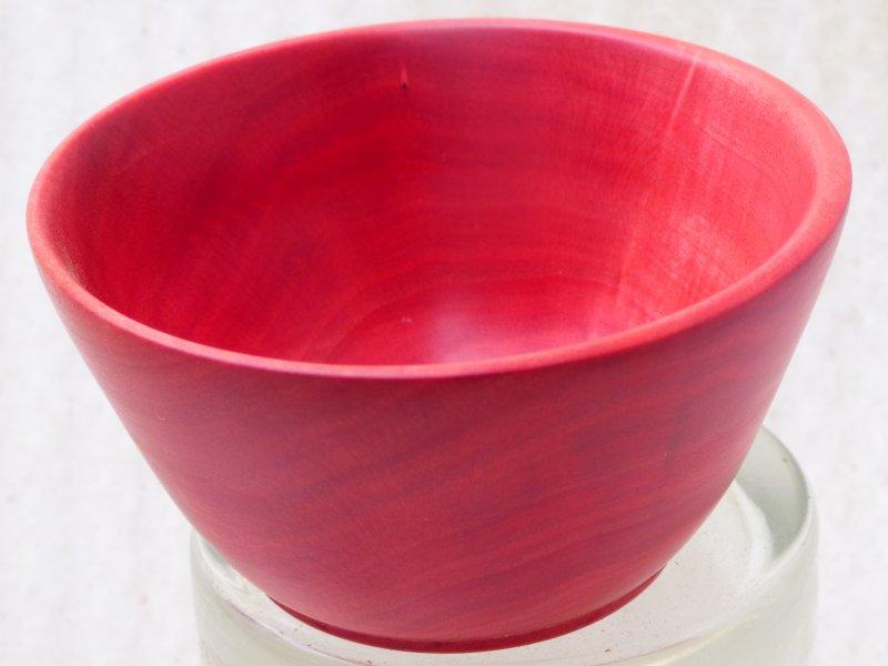 A turned bowl made from red/pink ivory.